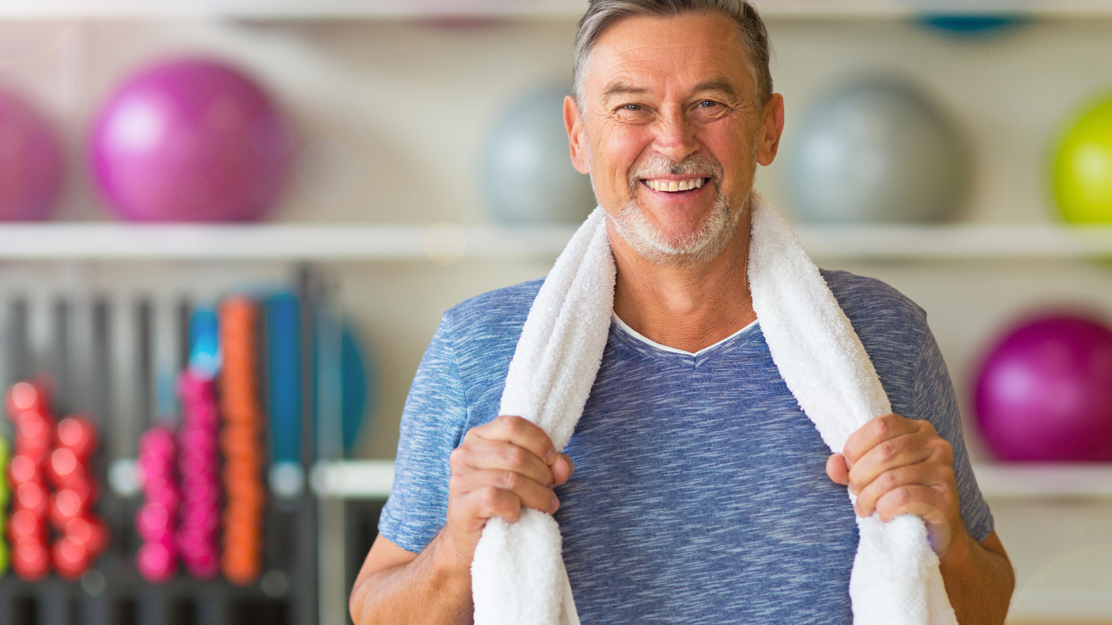 Grandpa at the gym holding towel 
