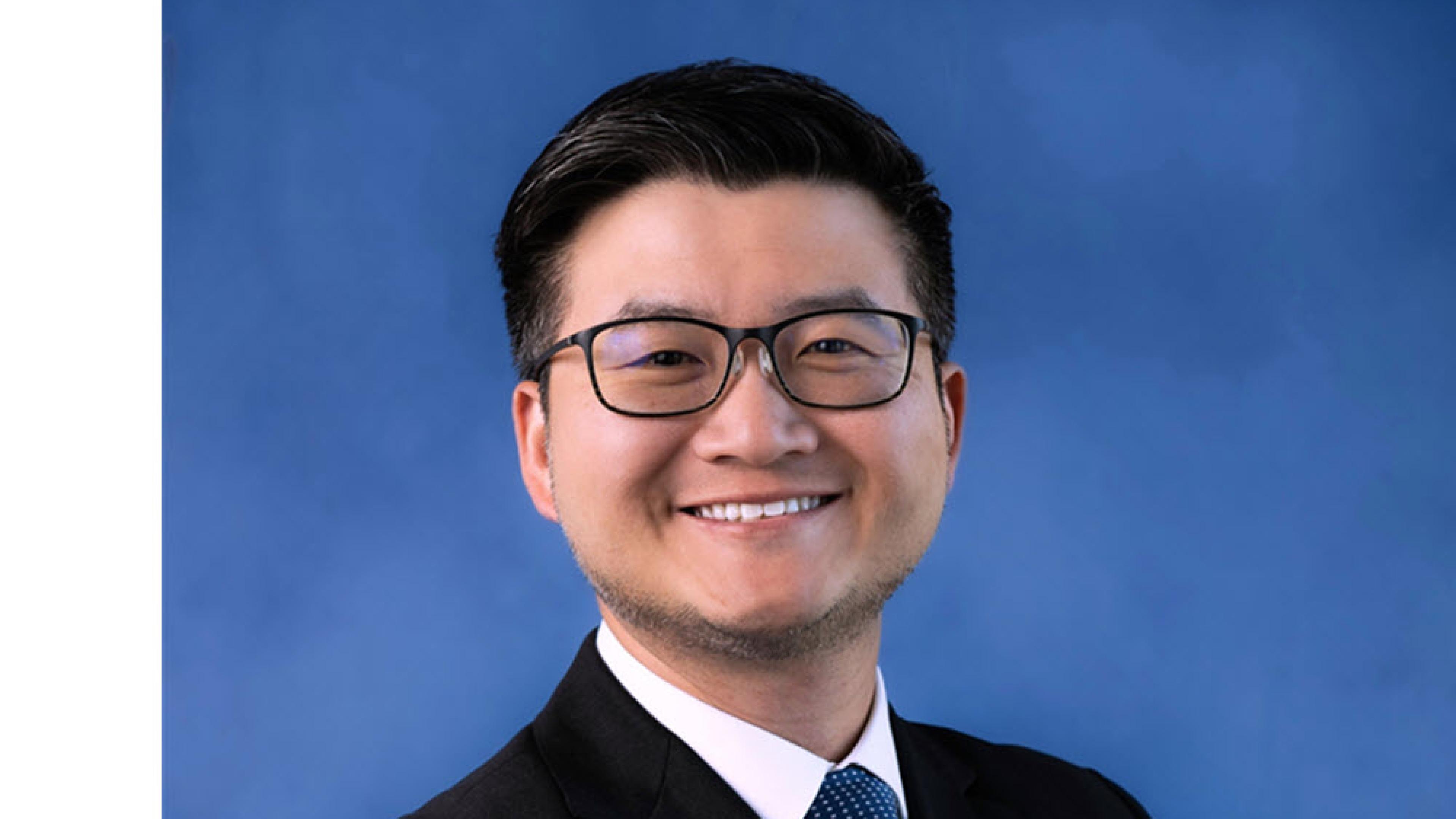 Dr. David Wang on a blue background.