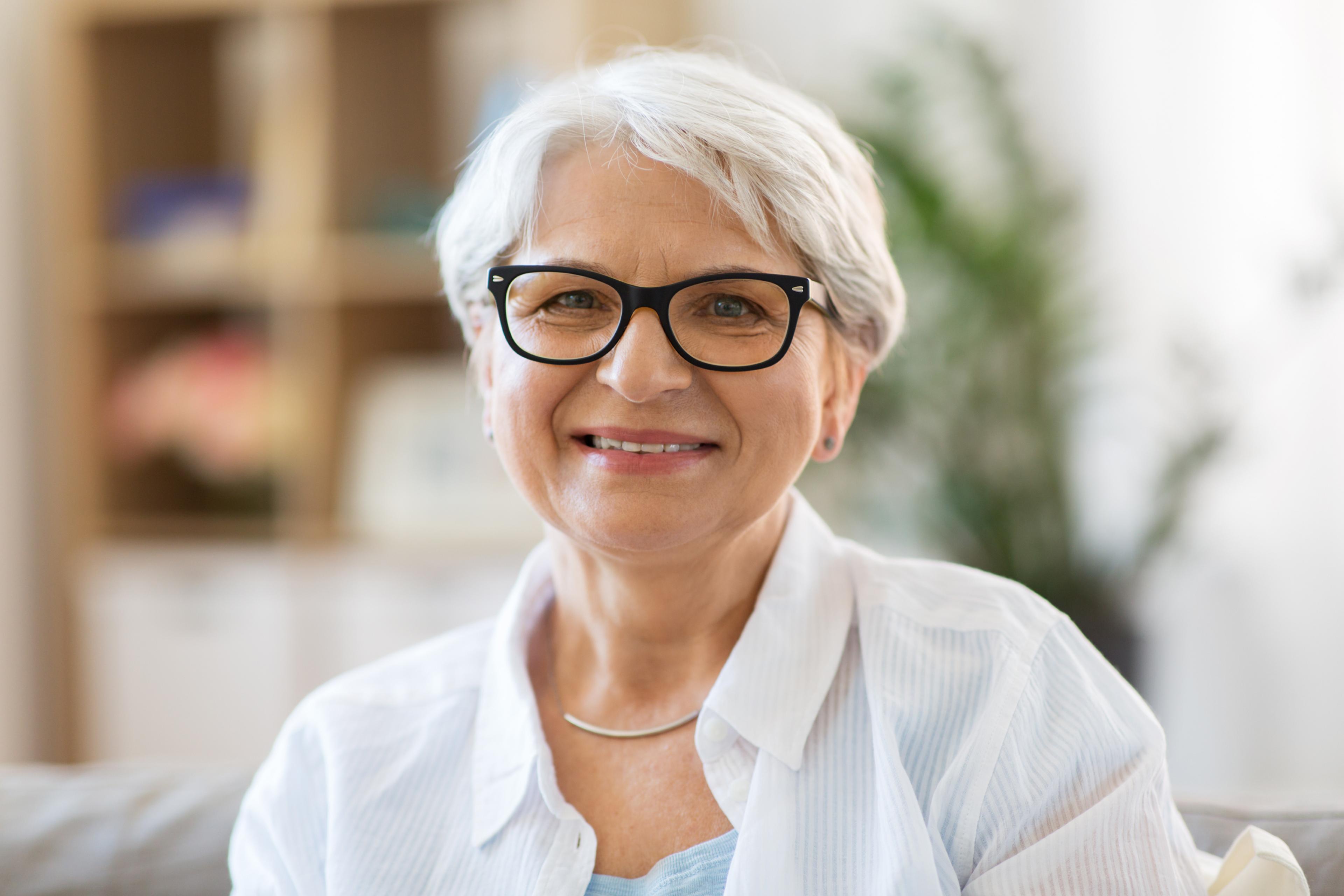 Elderly woman in glasses smiling