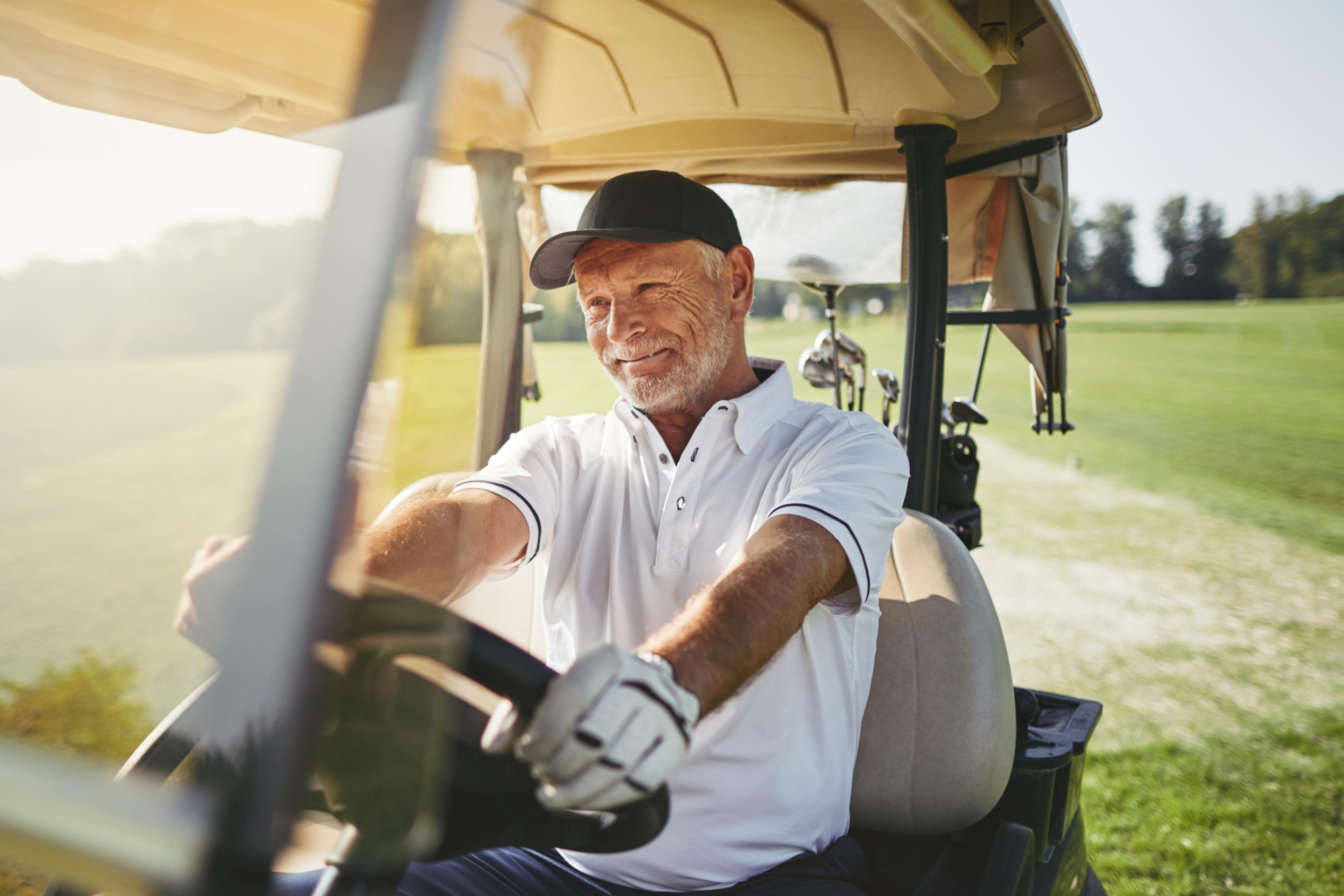 Elderly man in a golf cart 