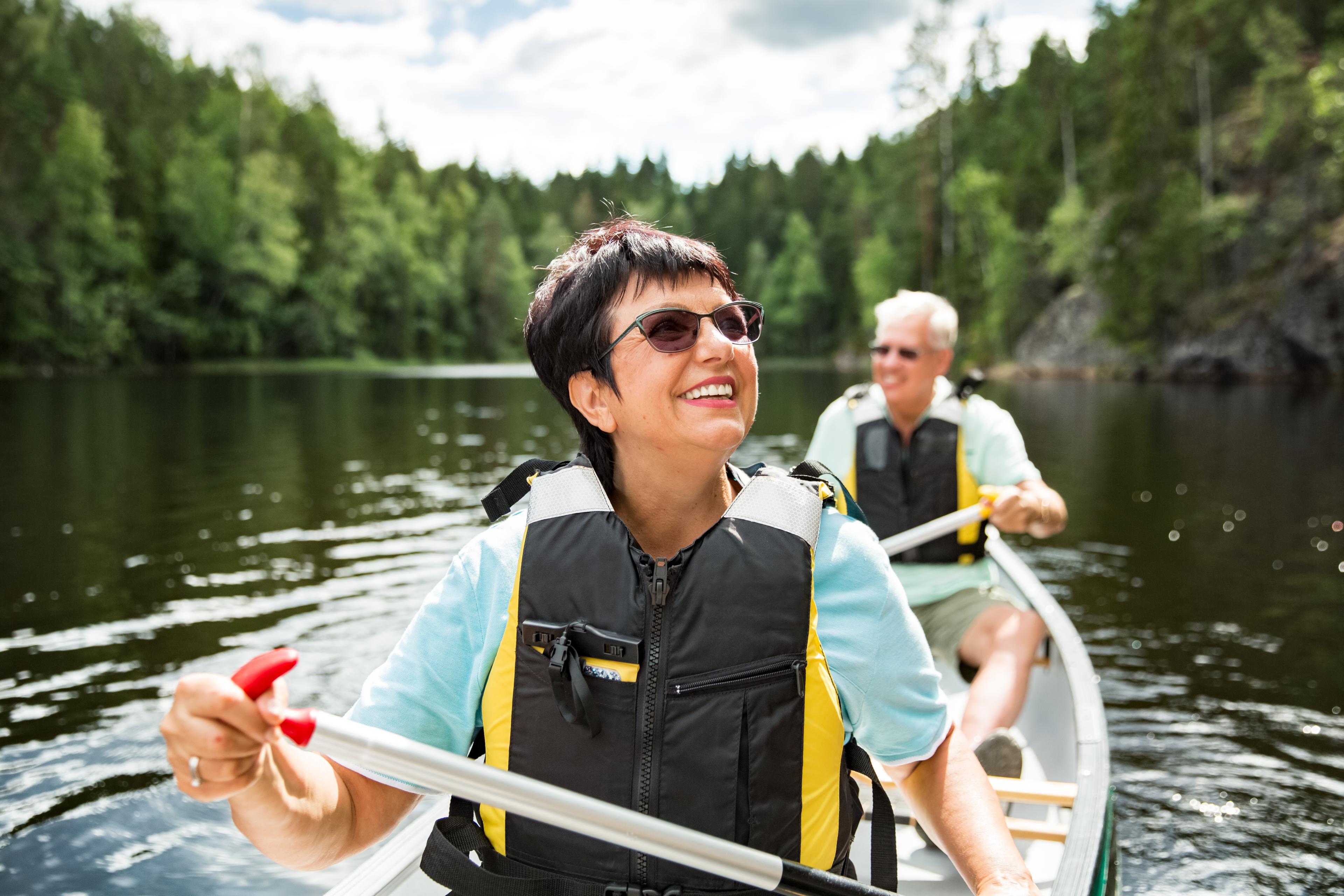 Older couple kayaking on a lake