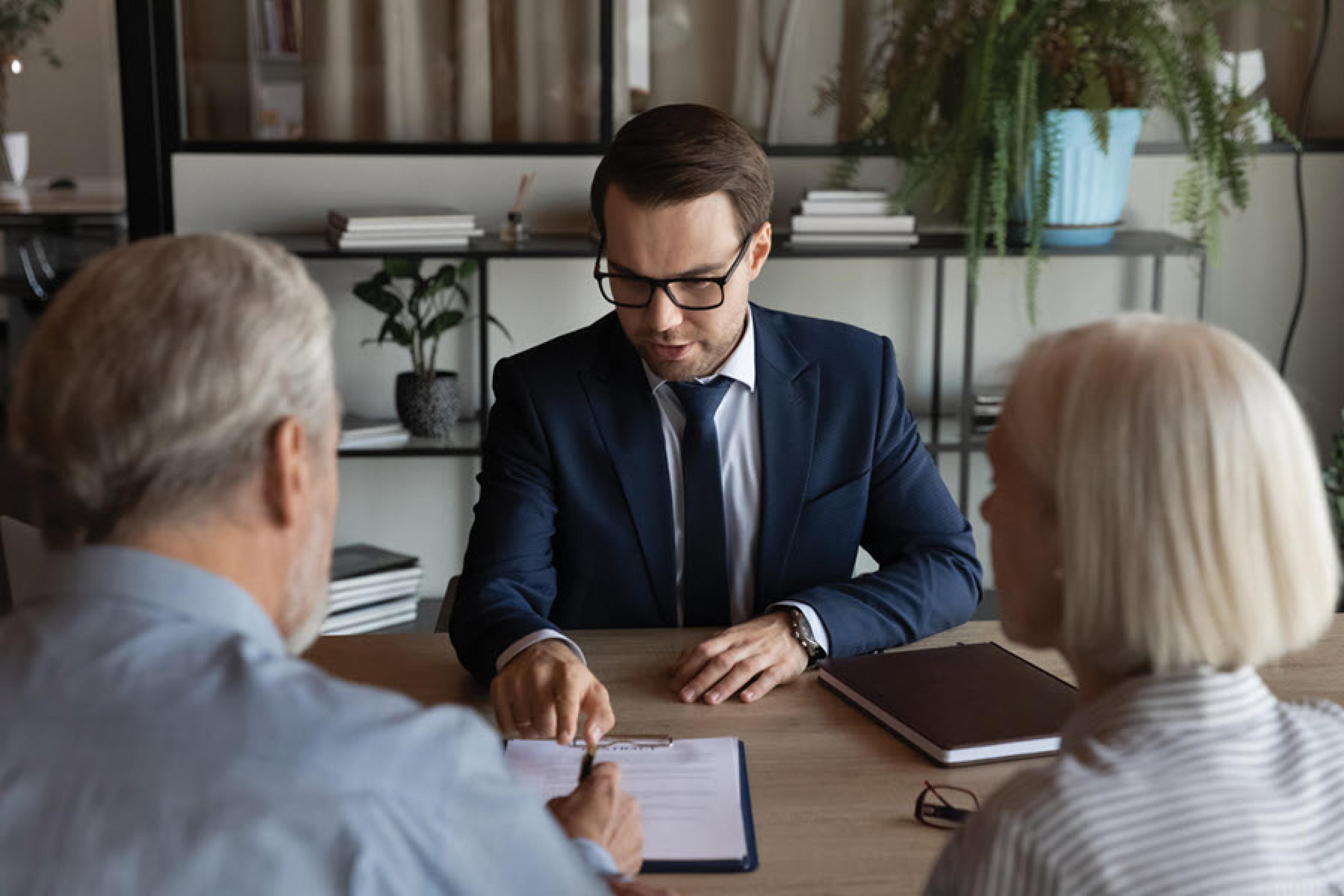 A couple is shown meeting with a Mass Advantage broker.